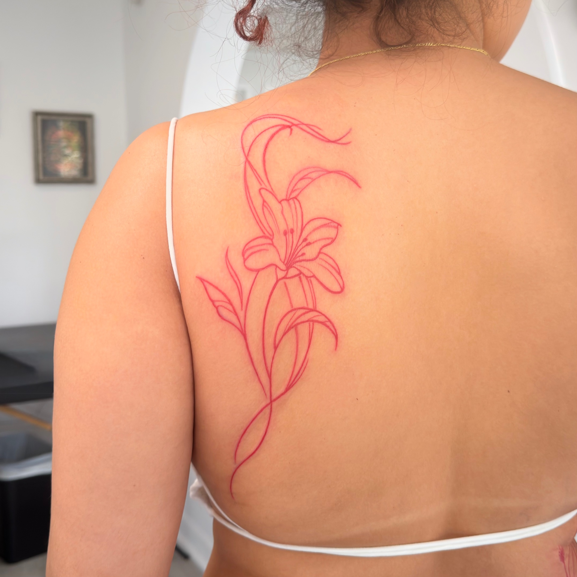 Red lily back tattoo