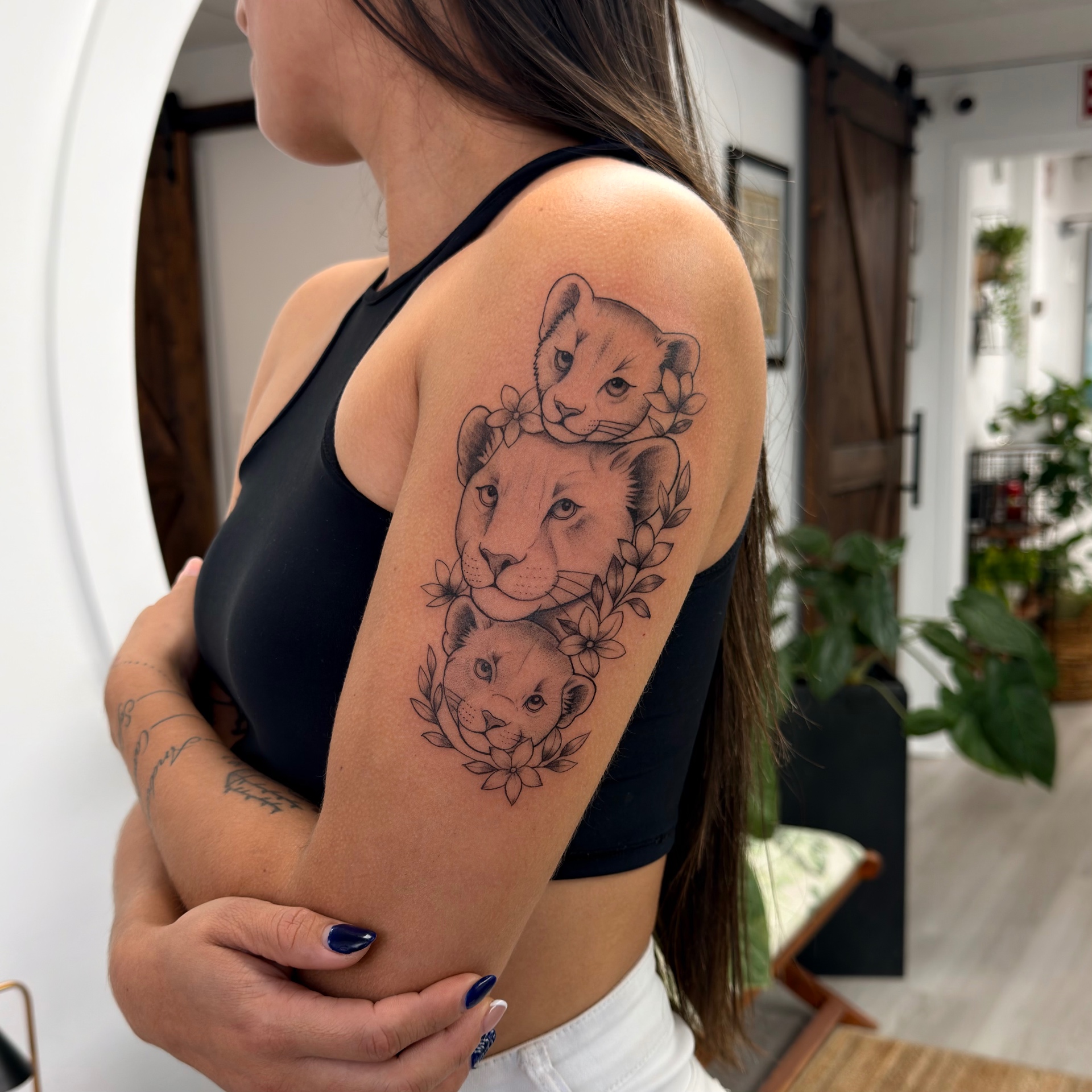 Lioness and cubs arm tattoo
